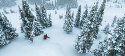 skier in deep snow skiing between skis