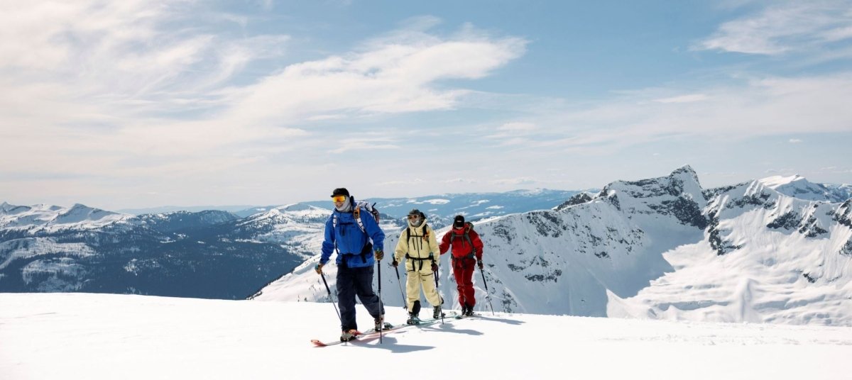 person holding up a climbing skin about to put it on a ski