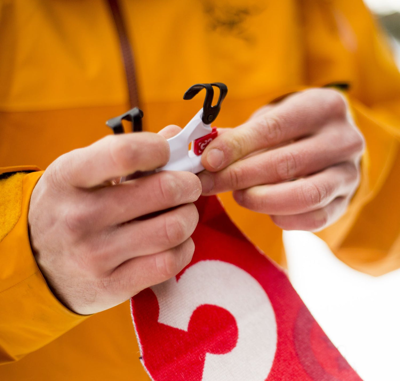 close up of person installing skin tip connector to climbing skin