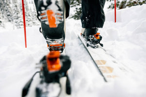 close up of boots and bindings while a person is ski touring